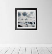 Framed artwork on a white wall with a wooden floor