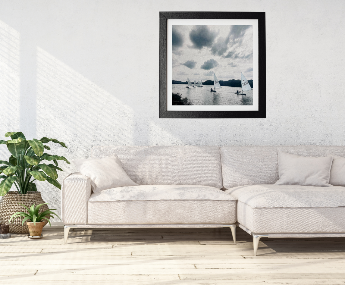 Framed artwork above a white sofa in a minimalistic living room.