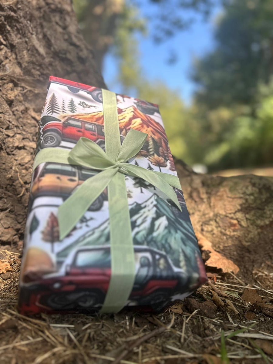 Winter mountain adventures in a 4 x 4 off road vehicle wrapping paper. FSC certified, uncoated 120gsm, 500mm x700mm