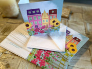 Flowery houses in bloom greeting card with hand embossed envelope. Colourful, FSC certified with printed sunflowers inside. Blank for your message