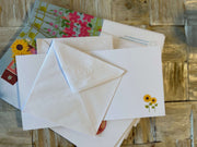 Flowery houses in bloom greeting card with hand embossed envelope. Colourful, FSC certified with printed sunflowers inside. Blank for your message