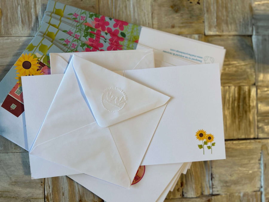 Flowery houses in bloom greeting card with hand embossed envelope. Colourful, FSC certified with printed sunflowers inside. Blank for your message