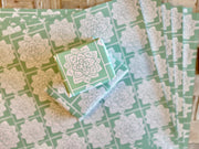 Wrapping paper inspired by Sindhi Ajrak block printing. Intricate white geometric & floral motifs on mint-green background. The repeating symmetrical pattern reflects traditional craftsmanship with a modern twist.