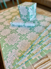 Wrapping paper inspired by Sindhi Ajrak block printing. Intricate white geometric & floral motifs on mint-green background. The repeating symmetrical pattern reflects traditional craftsmanship with a modern twist.