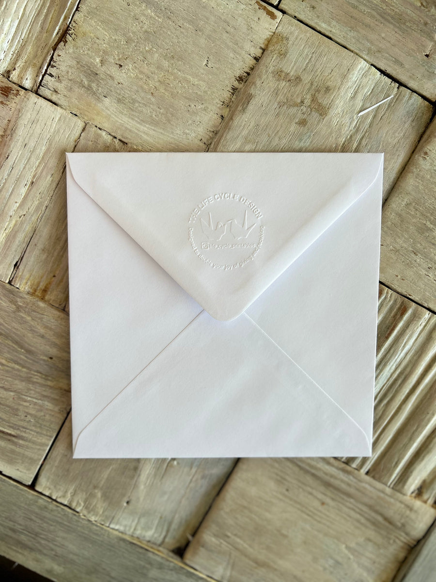 Hand embossed recycled envelope accompanying the card.