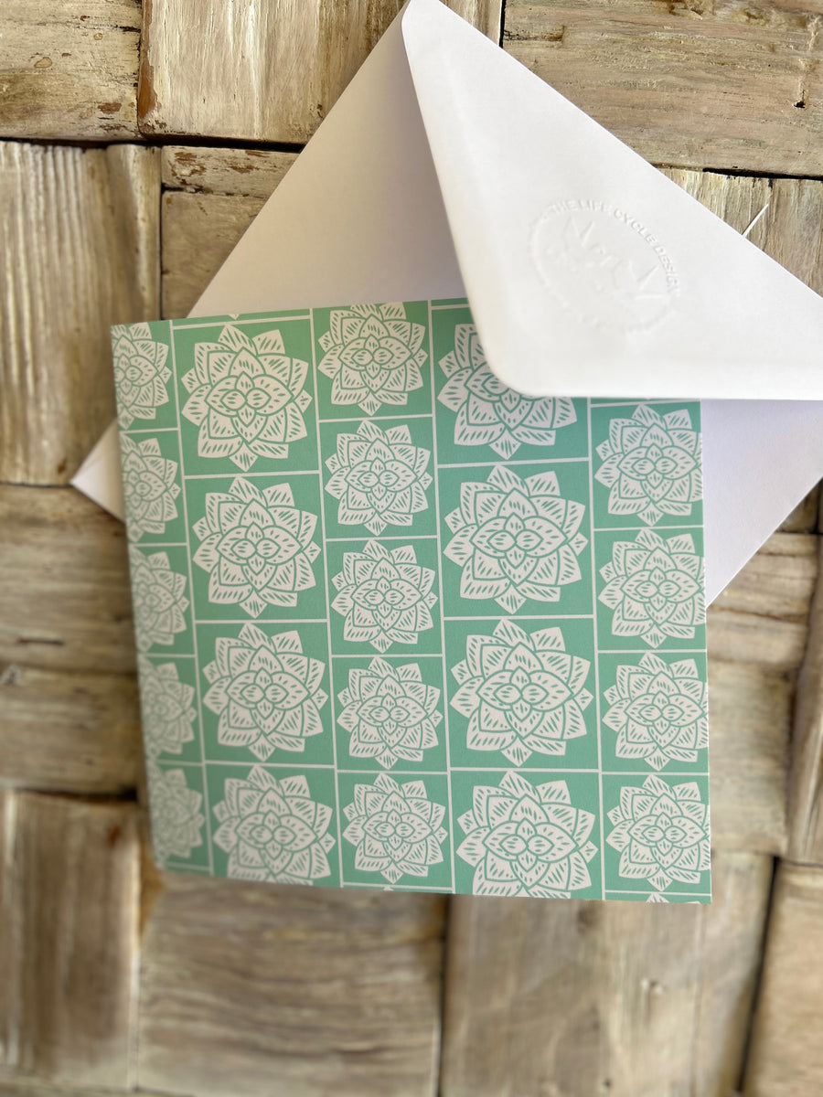 Greeting card inspired by Sindhi Ajrak block printing. Intricate white geometric & floral motifs on mint-green background. The repeating symmetrical pattern reflects traditional craftsmanship with a modern twist.Wrapping paper also available.