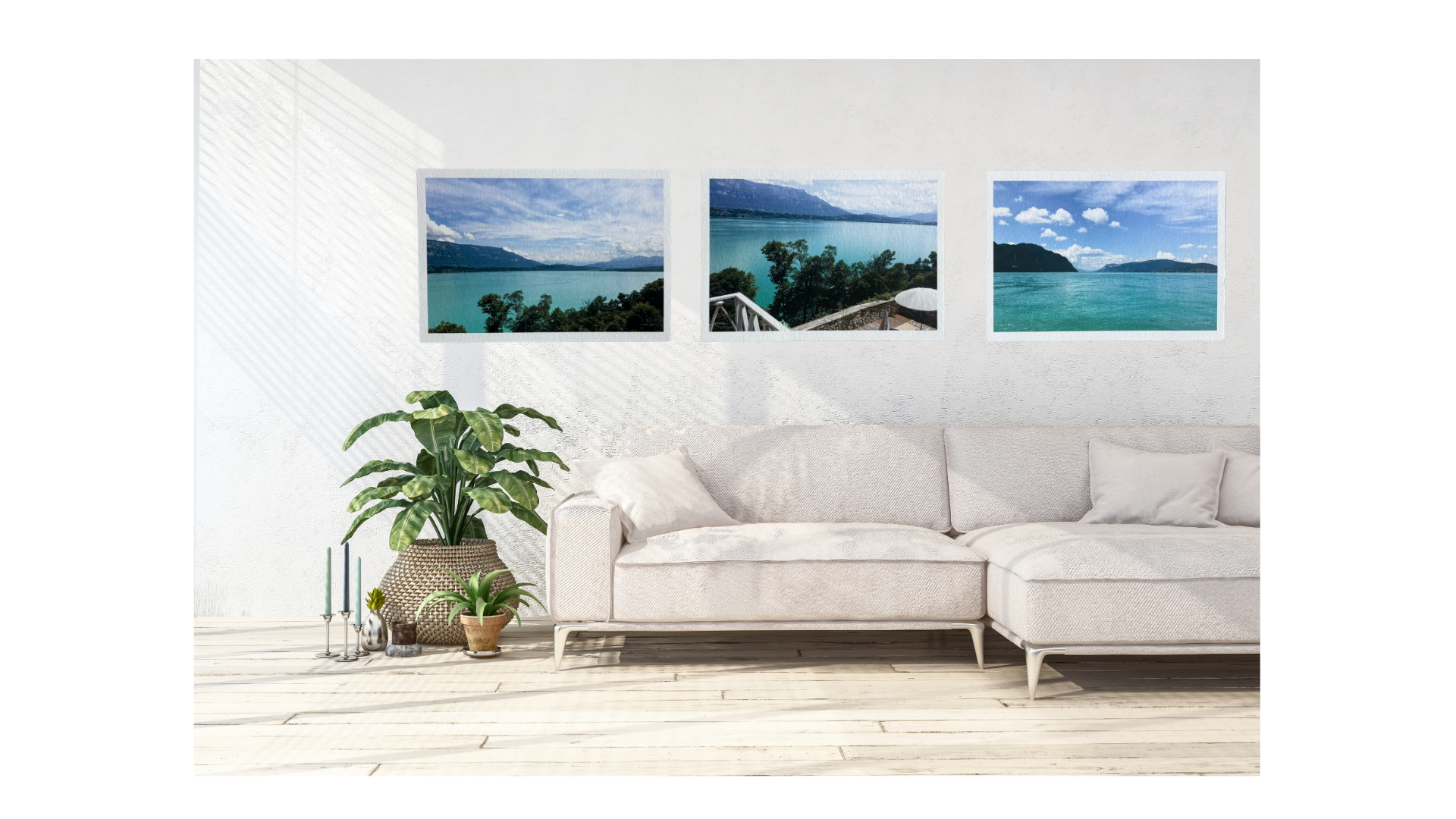 Living room with a white sofa and three framed pictures of a lake on the wall.